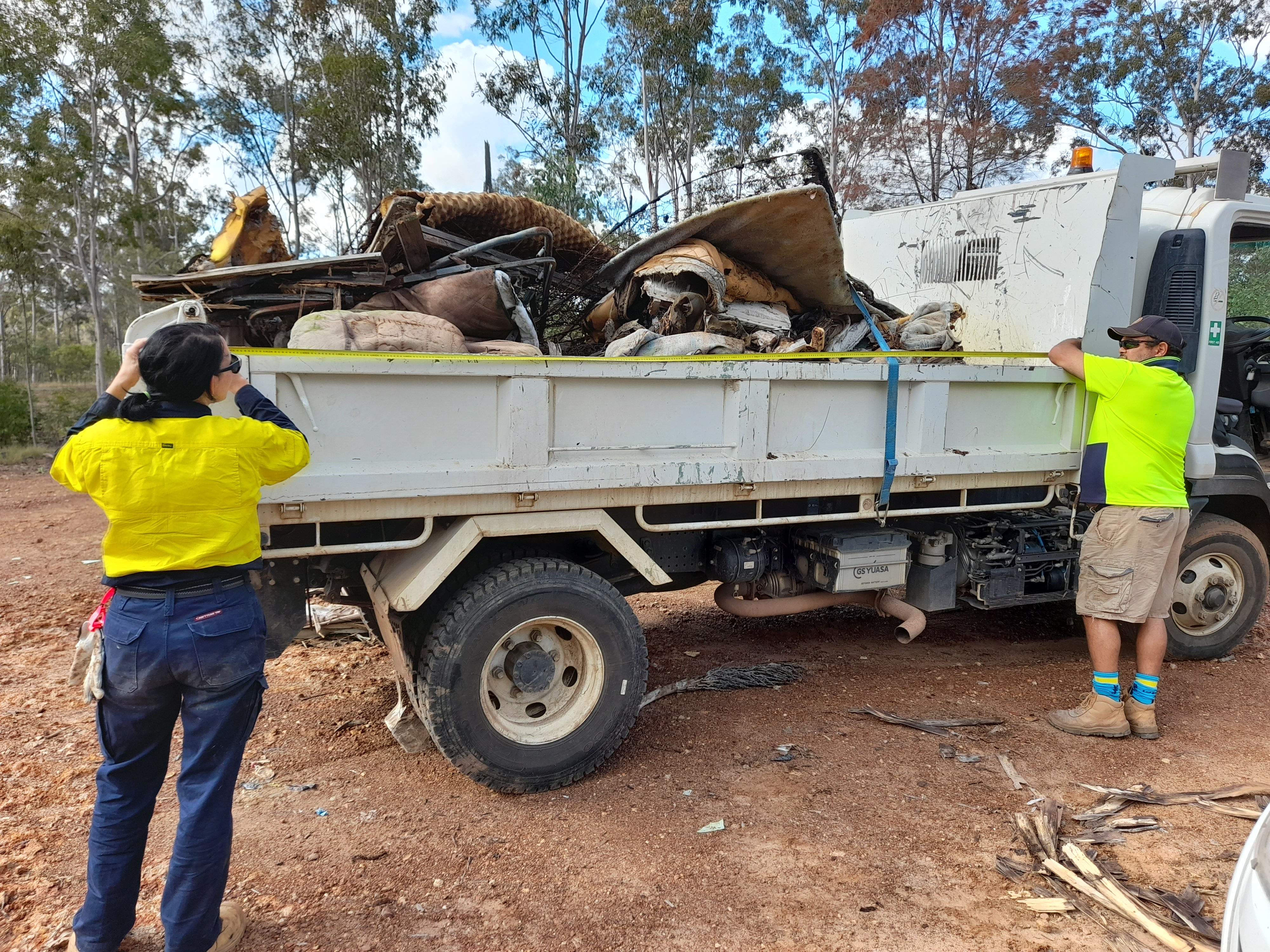 Images (2): Cherbourg Aboriginal Shire Council and South Burnett Regional Council working together to clear an illegal dumping site towards a sustainable future for our region